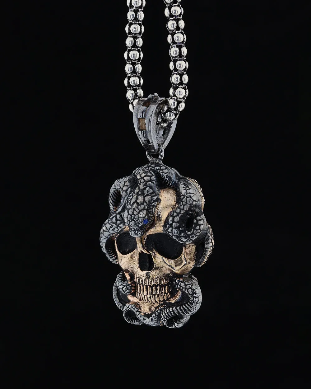 Skull and snake figure necklace