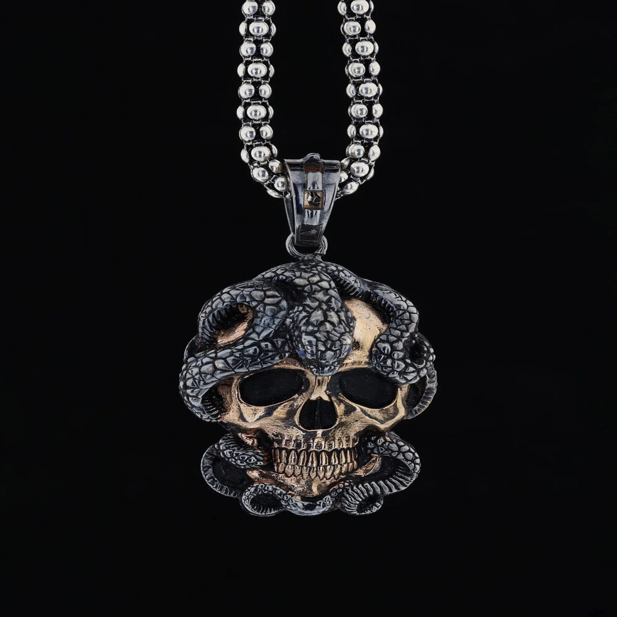 Skull and snake figure necklace
